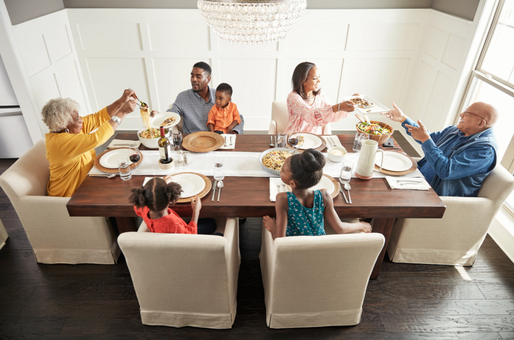 Happy family enjoying breakfast | Hadinger Flooring